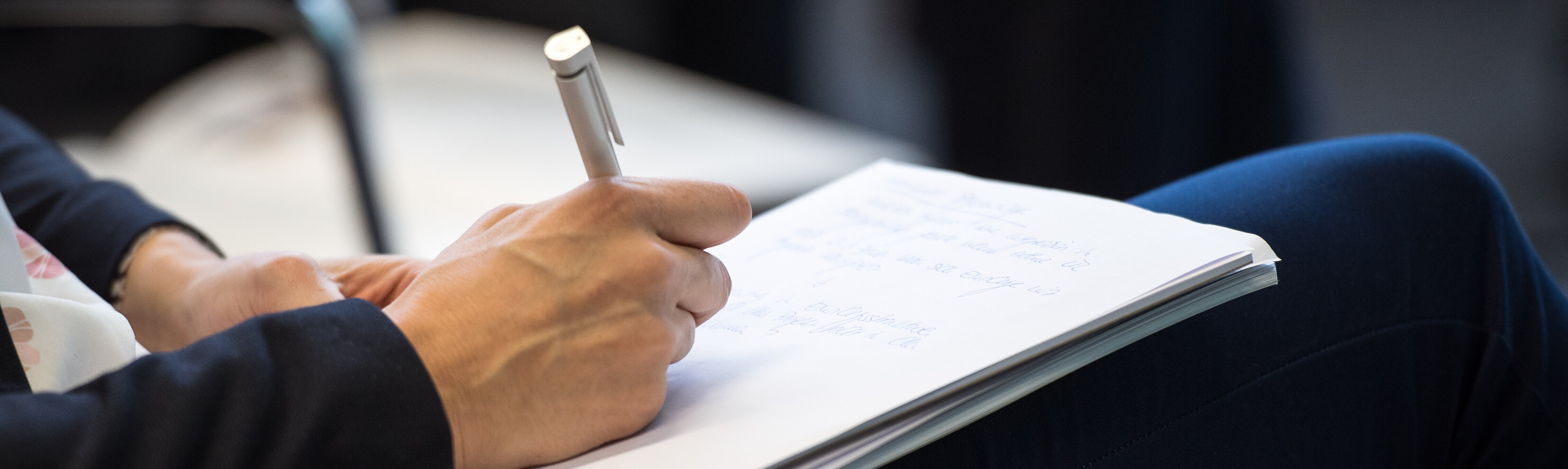 Downloads - Ansicht: Person füllt Antragsbogen aus Downloads - Ansicht: Person füllt Antragsbogen aus